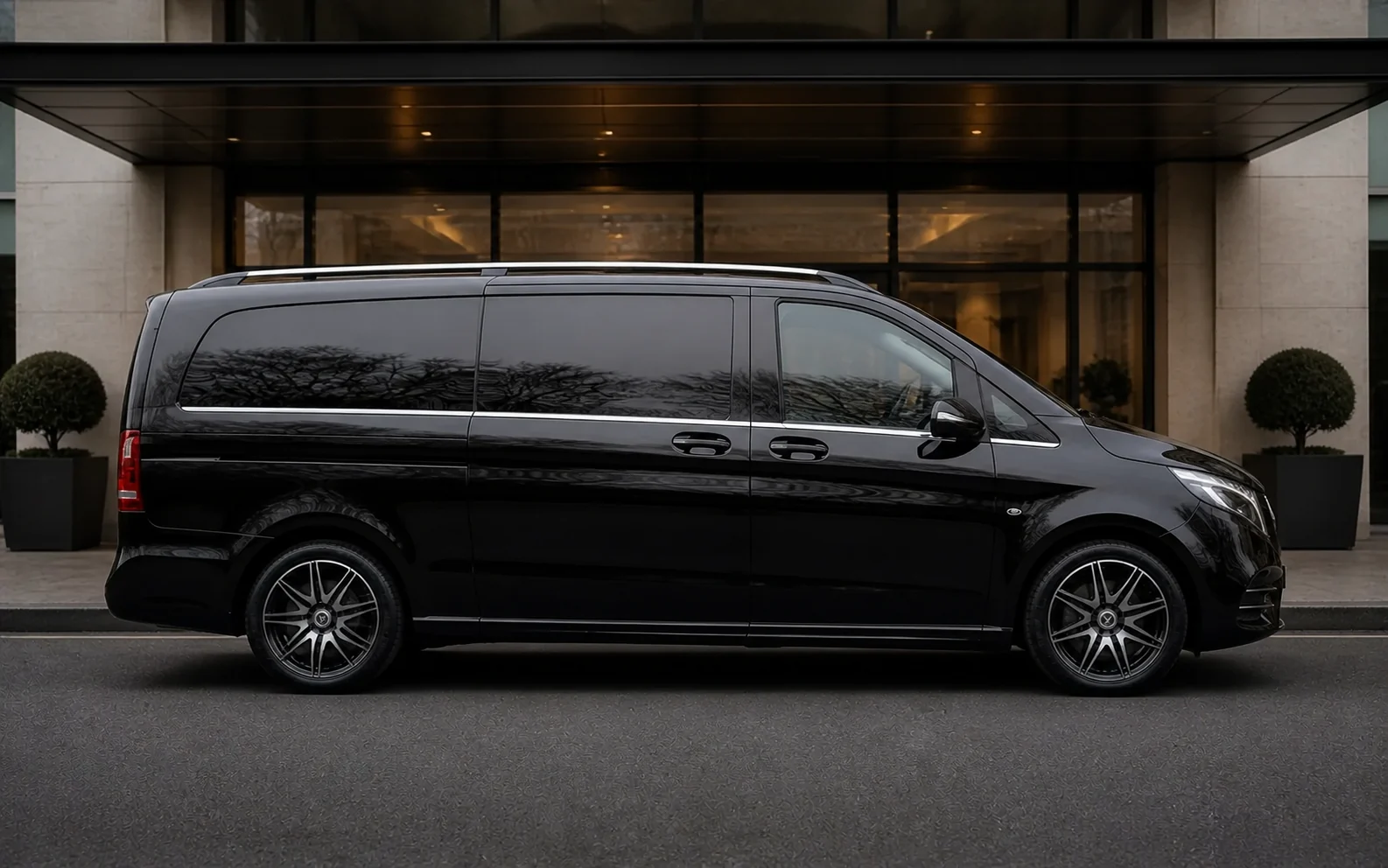 Full side profile of Vectura's black Mercedes-Benz V-Class Extra Long